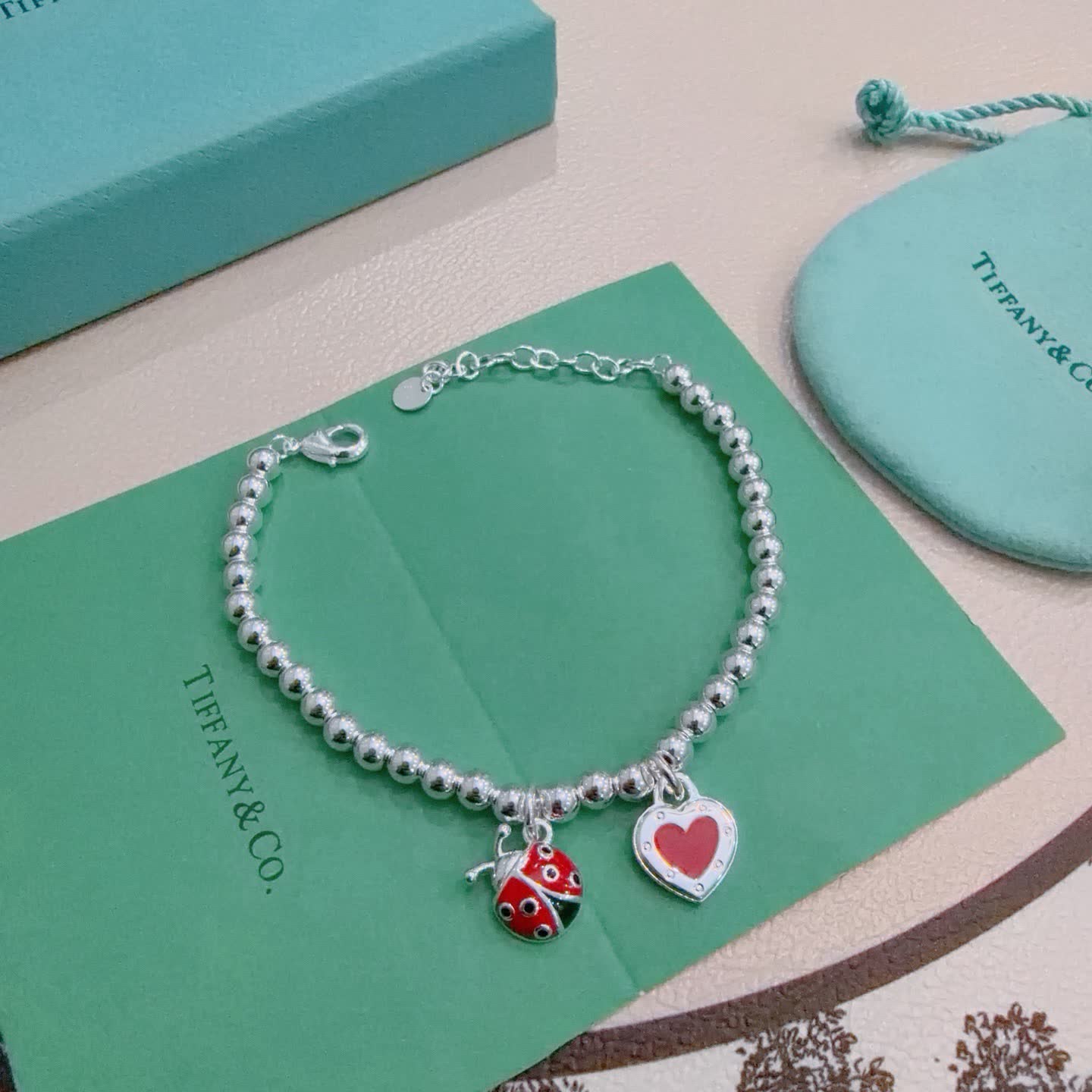 Tiffany & Co. Silver Bead Bracelet with Ladybug and Heart Charms